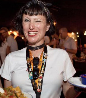 Female Hard Rock employee winks her eye and smiles for the camera