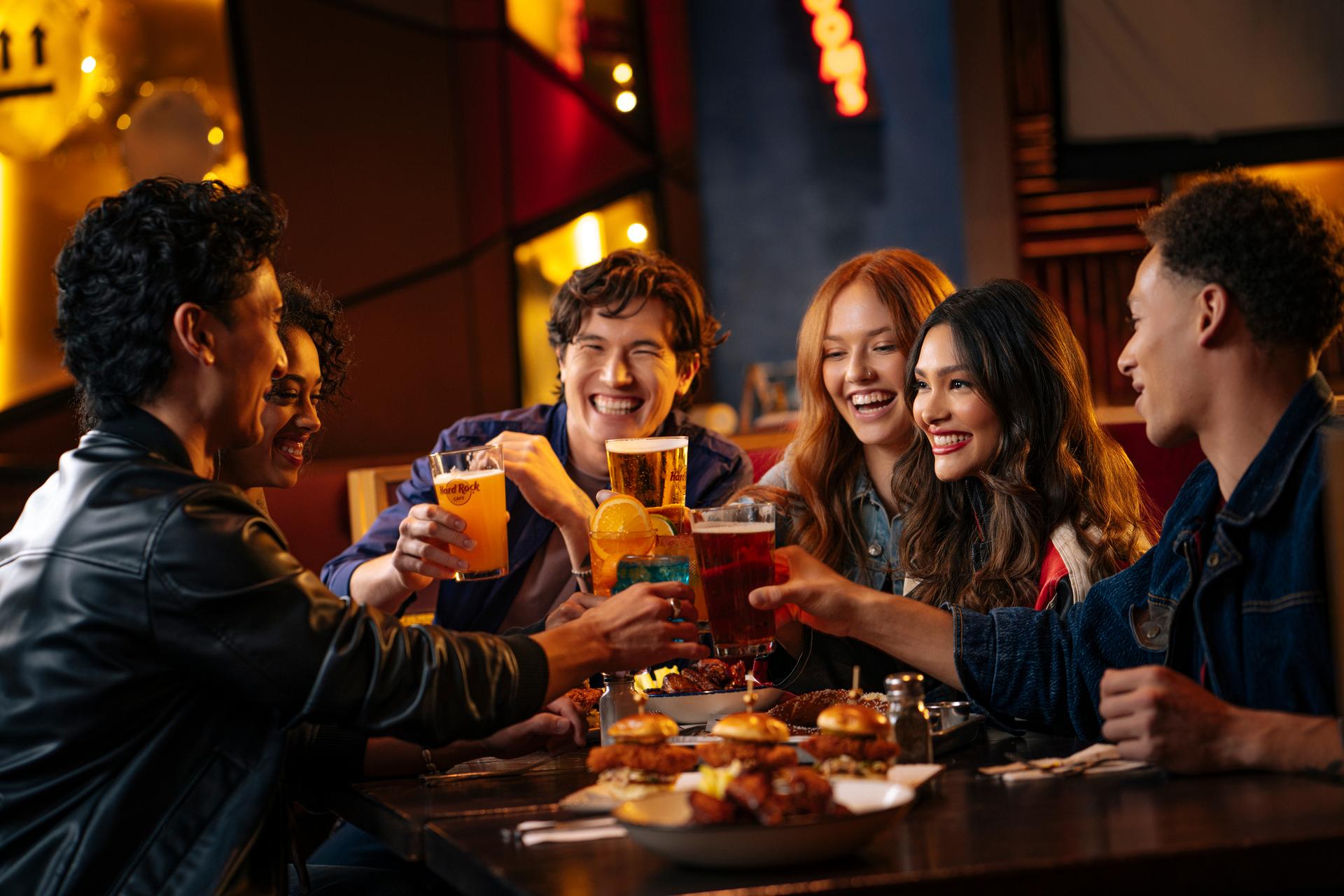 group of people enjoying themselves at a dinner table