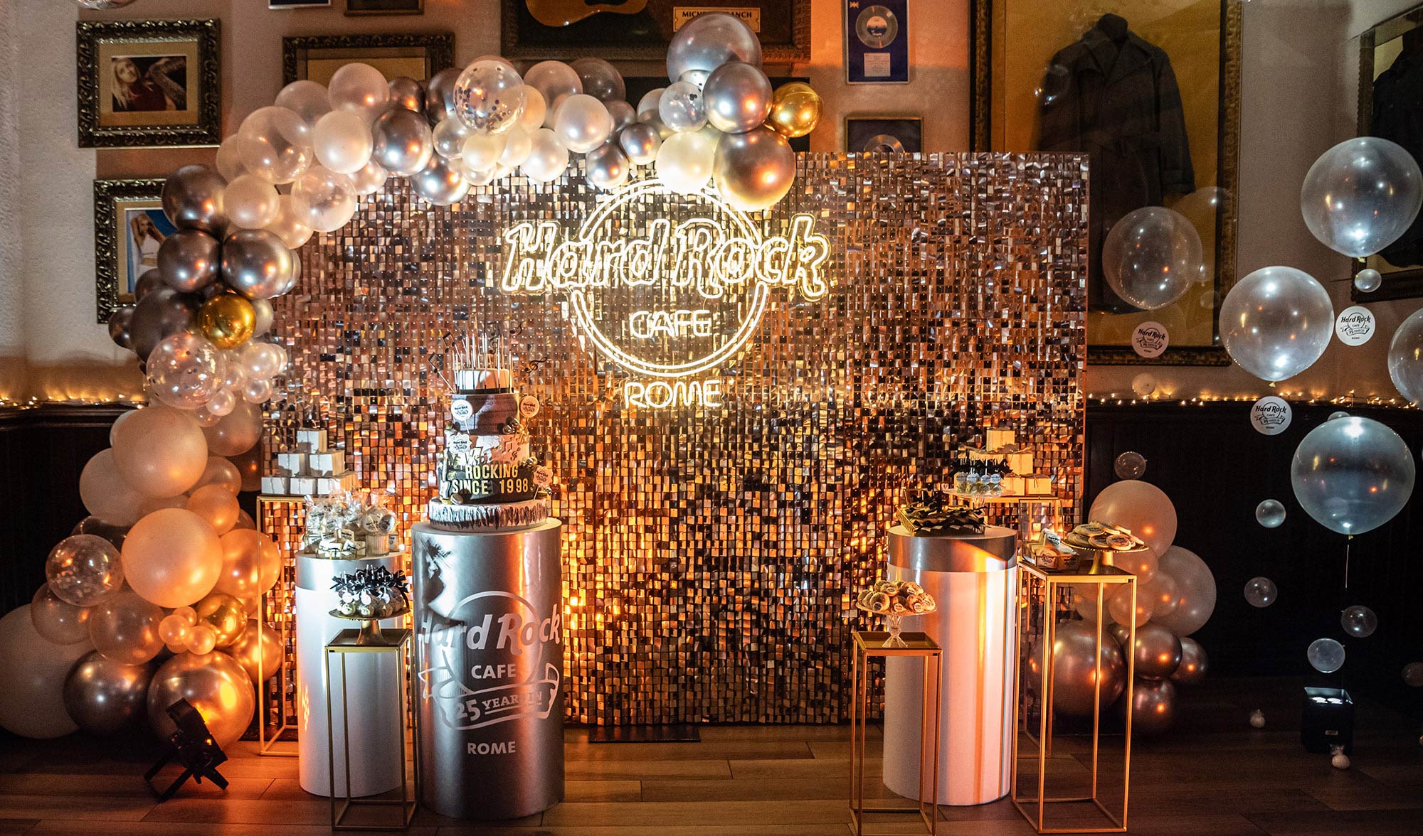 a party with balloons and a cake