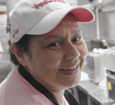 Hilda smiling at work in the kitchen