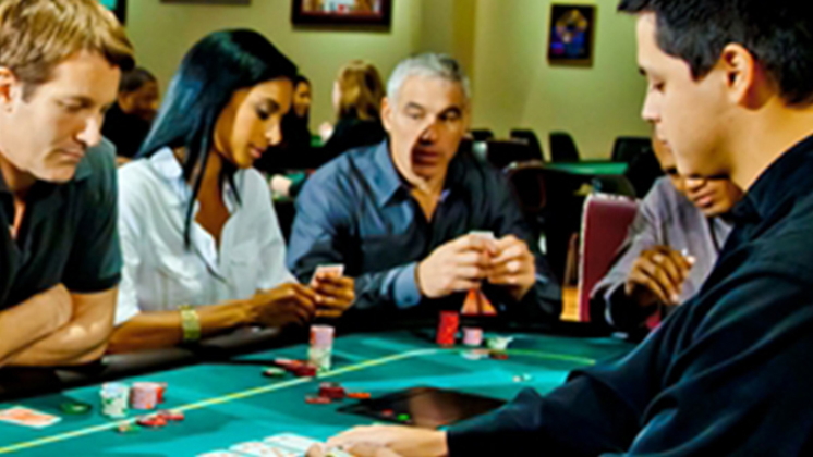 Poker Players Watching Dealer Lay Cards on Table