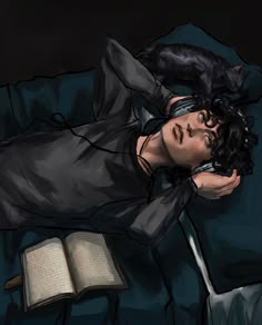 a man laying on top of a bed next to an open book with a cat on his shoulder