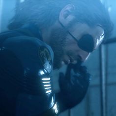the metal gear character is holding his hand to his face