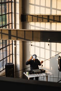 a man in a black shirt is playing music on a dj's turntable