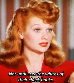 an old photo of a woman with red hair wearing a red dress and posing for the camera