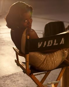 a woman sitting in a chair with her legs crossed