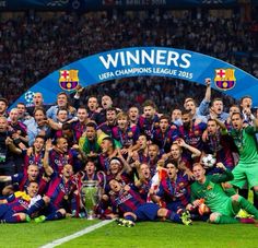 the barcelona team celebrate with the trophy
