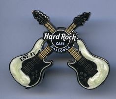 two black and white guitars with the words hard rock cafe on it's back