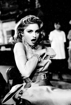 a black and white photo of a woman with her hands on her hips