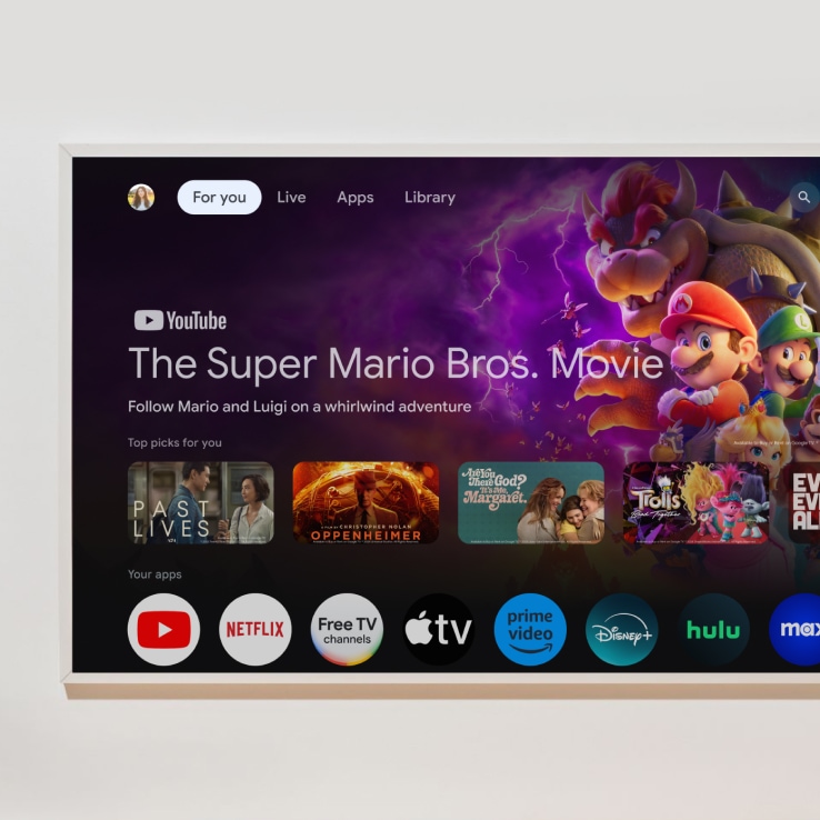 A smart TV home screen showing various movie selections and streaming service icons.