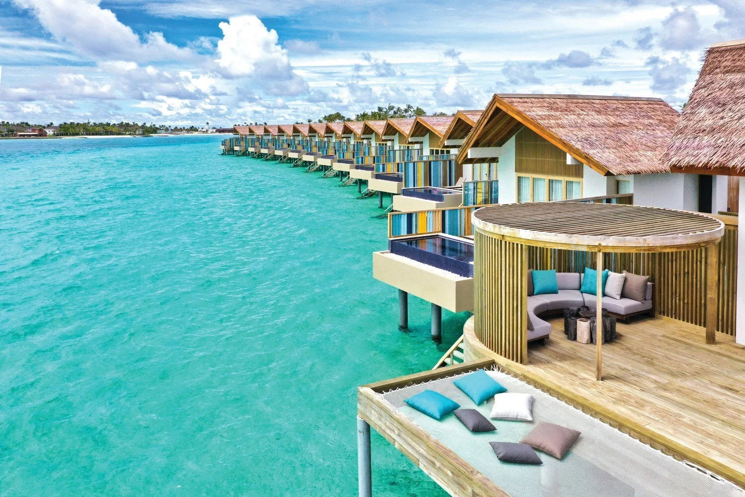 Cabanas sitting just above the water at Hard Rock Hotel Maldives 
